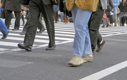 Low angle image of a people crowd crossing the street